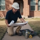 Engineer inspecting Texas home foundation outdoors