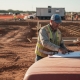 Engineer reviews blueprints at Texas construction site