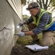 Engineer inspects cracked house foundation