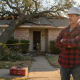 Homeowner inspects tree-fallen Texas roof